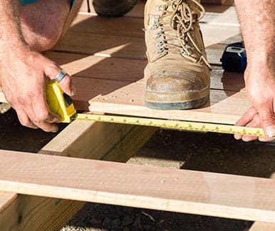 Man measuring decking for home renovations